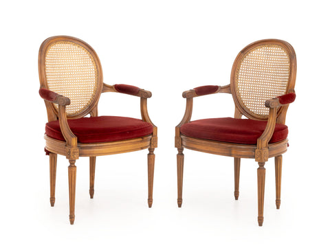 Pair of Louis XVI Style Red Velvet Upholstered Cane Paneled Walnut Fauteuils